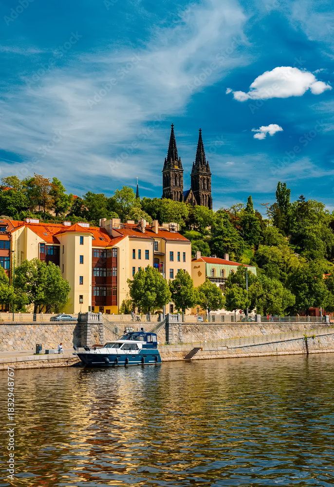 Fototapeta premium Vysehrad Basilica and colorful buildings along Vltava embankment.