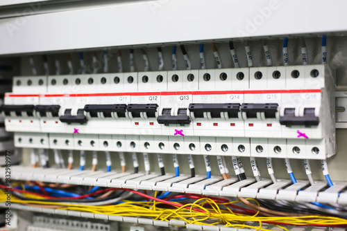 Electric circuit breaker on wall. Power equipment for electrification. Automatic switch for turning on and off high-voltage home appliances. Electric circuit breaker with black switches