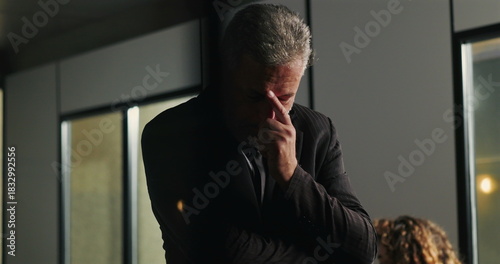 Quadro em tela Thoughtful businessman standing in office with hand on chin while processing ser