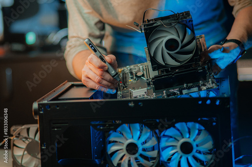 Man assembles a computer system unit at home