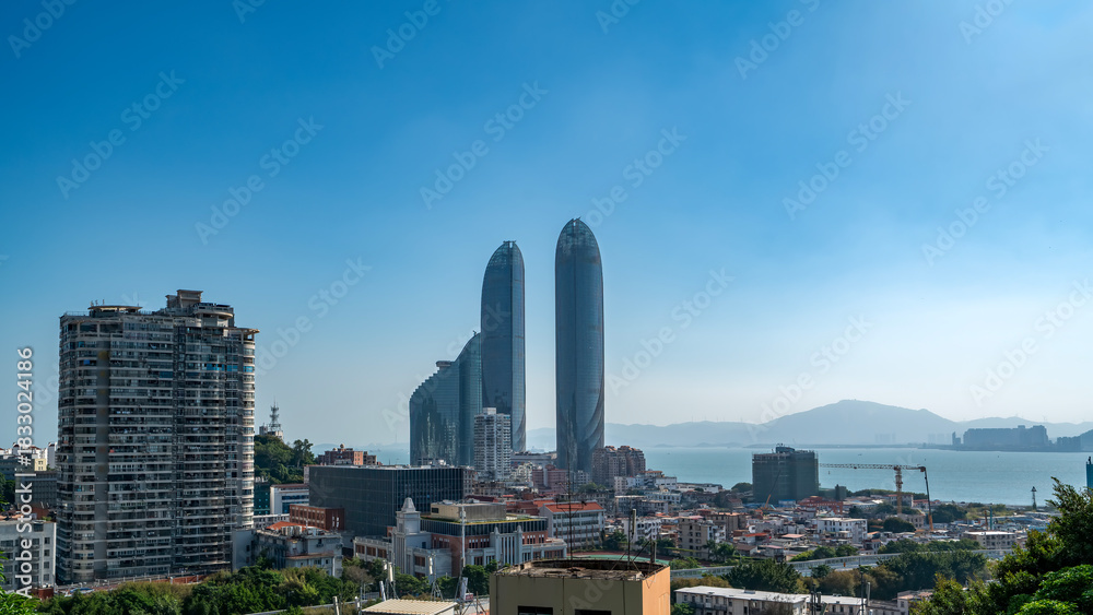 Fototapeta premium Modern cityscape with tall skyscrapers under clear blue sky