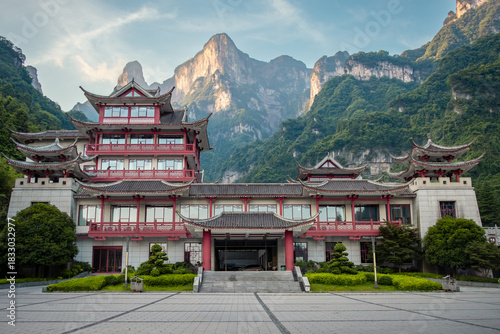 Wooden chinese style architecture builing at the entrance to Tianmen Mountain with a mountain in the background. Photo taken in Zhangjiajie Hunan