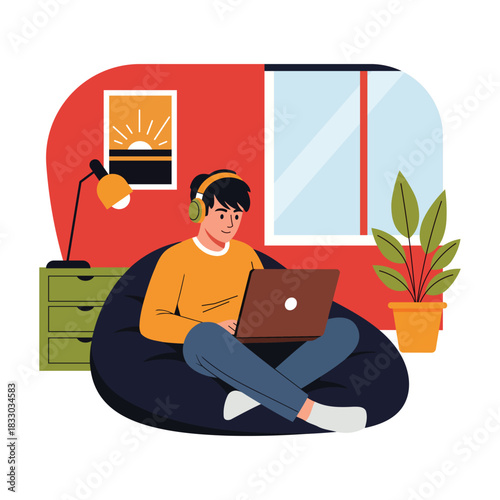 Young Man Working from Home on Beanbag with Laptop and Headphones