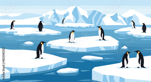 Colony of emperor penguins standing on floating ice floes in the cold arctic ocean with large icy mountains in the background.