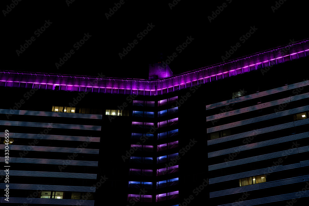 Fototapeta premium Moscow High-Rise with Purple and Blue LED Facade at Night