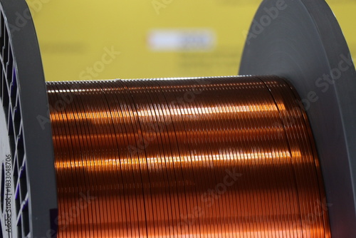 Enameled copper of flat wire type on a spool. Flat copper used in electric motors