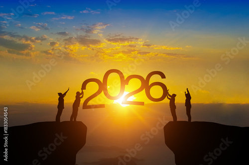 Silhouette teamwork raising hands toward “2026,” symbolizing new goals for the new year.