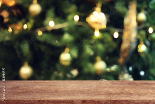 Background of blurred Christmas tree and empty table for mockup