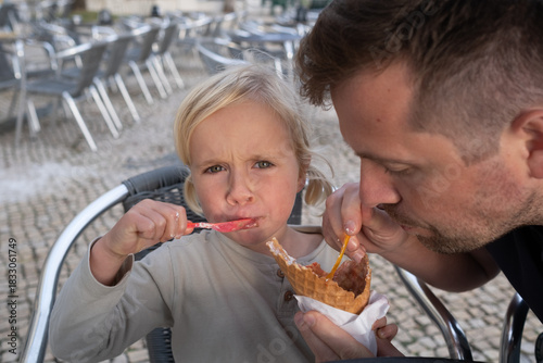Girl Eating Ice Cream with Her Dad at a Cafe