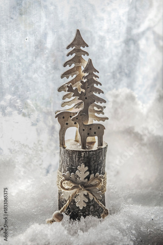 Christmas decoration representing a wooden fir placed in the snow in front of...