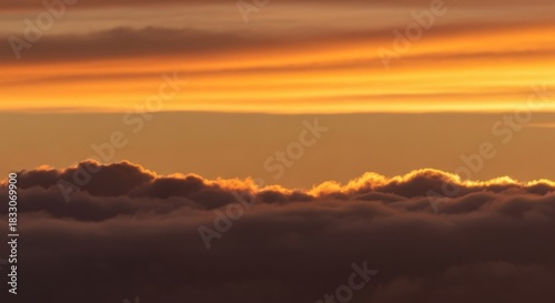 Golden sunset cloudscapes over a hazy horizon