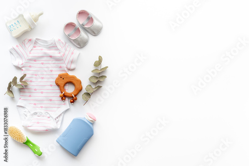 Wallpaper Mural Set of baby hygiene cosmetic products - shampoo and soap with a comb. Eco friendly accessories - bodysuit and wooden toys with bottle of milk on white background, top view Torontodigital.ca