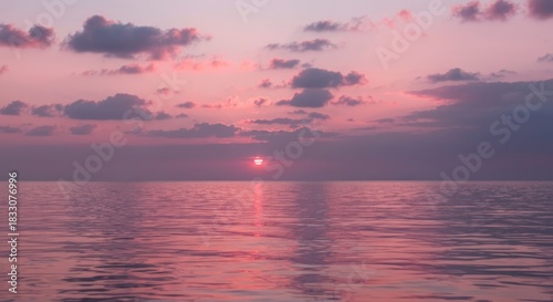 Soft, pastel sunset over a placid ocean