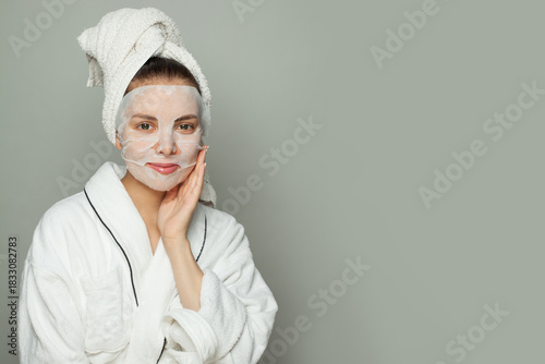 Locely woman taking care of her skin wearing sheet mask. Skin care and hydration concept