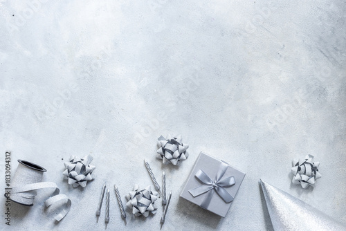 Wallpaper Mural Shiny party silver streamers with confetti and cones on gray stone background, top view Torontodigital.ca