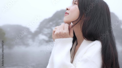  Beautiful young woman spinning in the winter snow in slow motion