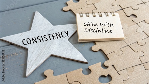Wooden star and puzzle pieces showing the words consistency and discipline