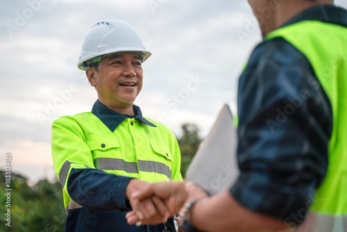 Картината върху платно Construction workers collaborate at job site urban setting photography professio