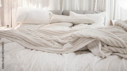 White knitted blanket on bed in bedroom, interior design concept.