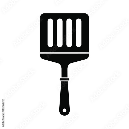 Black silhouette of a slotted spatula on white kitchen