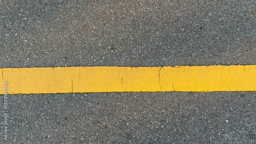 Fototapeta premium Top view of asphalt road with one yellow line.