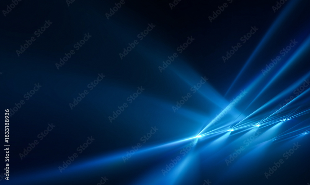 Fototapeta premium Abstract blue light rays and beams emanating from a corner on a dark background, creating a futuristic or stage lighting effect