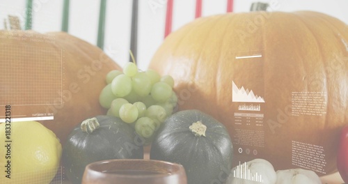 Showing centered autumn produce on tabletop with pumpkins, grapes, squashes, lemon and overlays