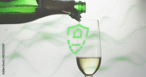 Pouring green bottle sending pale sparkling wine into studio champagne flute, with shield overlay