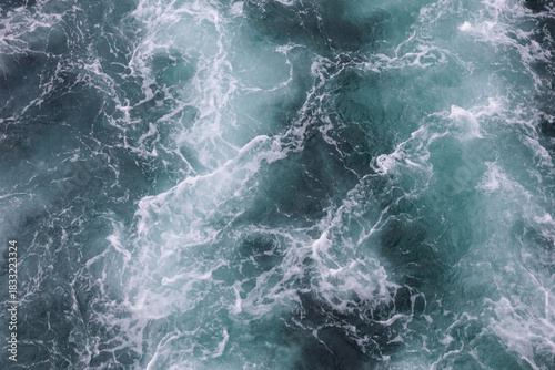 Water surface. Wake waves on the blue sea