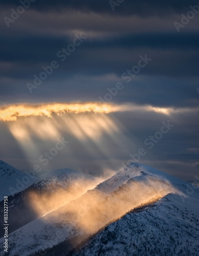 Majestic Mountain Landscape with Sunlight Breaking Through Clouds