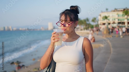 Mexican woman drinking tuba at sunset in Puerto Vallarta