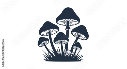 Dark silhouette of a cluster of mushrooms or toadstools growing in grass isolated on a white background.