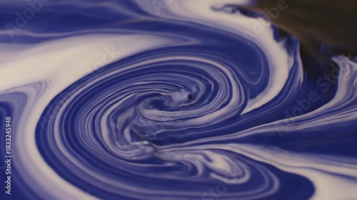 Swirling mixture of blue and white colors, creating abstract textures with dynamic curves