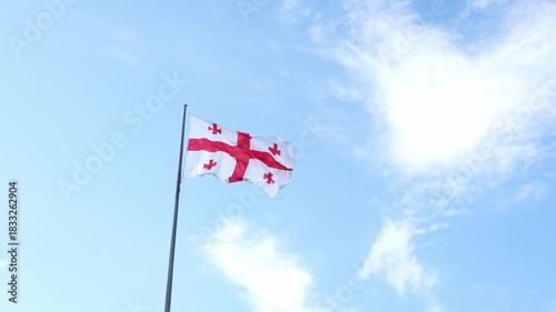 A video recording of the flag against the sky, taken by a drone in the Georgian city of Batumi on the Black Sea. Aerial photography. The flag of Georgia.