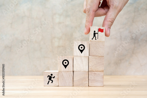 Career Path and Development Strategy Concept. Arranging wooden blocks with icons success roadmap and journey, symbolizing a structured career path and strategic development. Planning, growth, progress