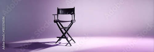 A modern black chair on the dark purple background.