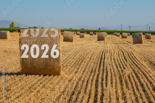 Happy New Year 2026 agricultural business concept. View of bales in the field.