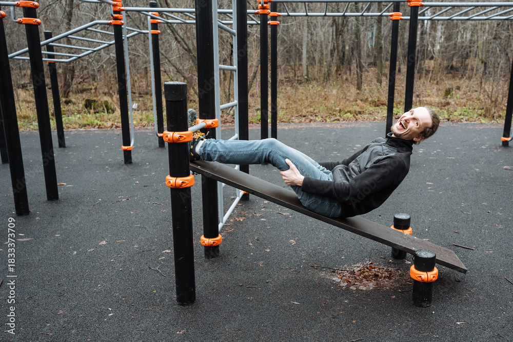 Fototapeta premium person unwinds after exercise outdoors, individual finds peace outside after physical activity, an individual relaxes peacefully outdoors after completing strenuous fitness routine