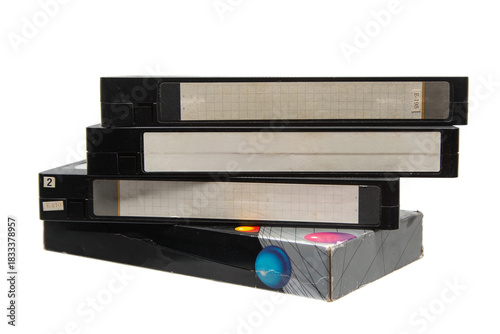 Stack of retro black VHS video cassette tapes.