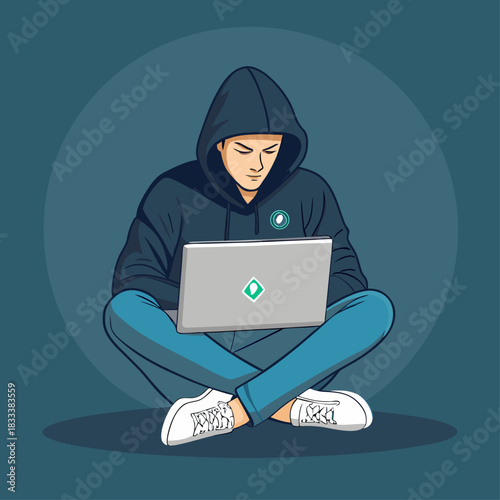 Un joven con sudadera de capucha y laptop trabaja sentado en el suelo con las piernas cruzadas, en un entorno moderno y digital.
