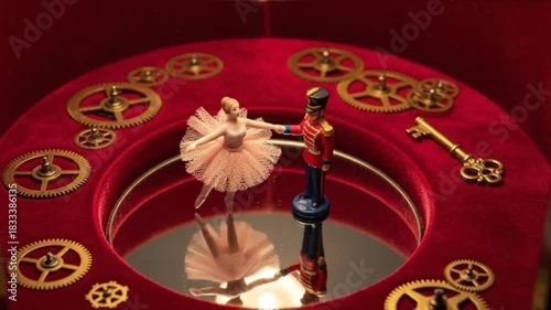 Dancing tin soldier and ballerina in a musical box surrounded by intricate gears and reflecting mirror
