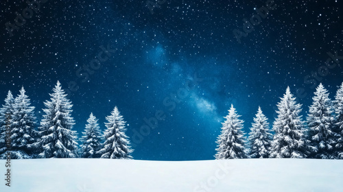 Enchanting deep blue winter night sky with snow-covered trees in tranquil forest landscape