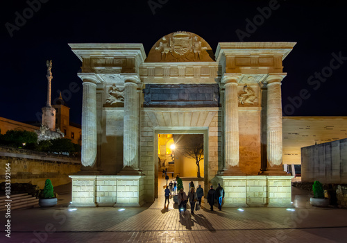 Puerta del Puente gate at Roman bridge at night, Cordoba, Spain