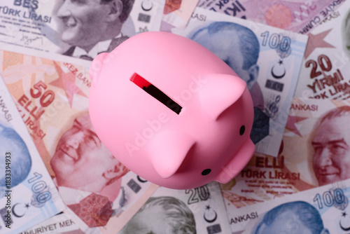 Fototapeta Naklejka Na Ścianę i Meble -  A piggy bank as a concept for storing, accumulating, and saving financial resources. A piggy bank