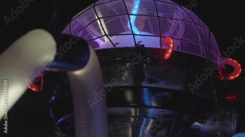 This video shows a mysterious, futuristic light up industrial sphere with multicolor light tubes. 