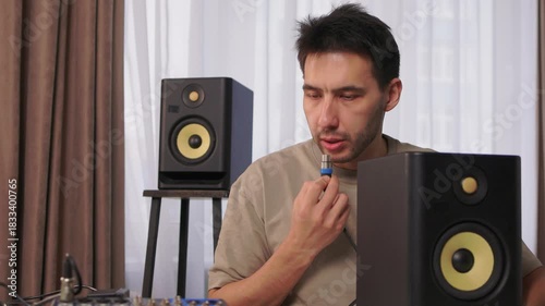 Home studio sound system adjustment, Decking speaker connections in recording space, Carefully connecting audio cables and calibrating sound levels in personal music studio