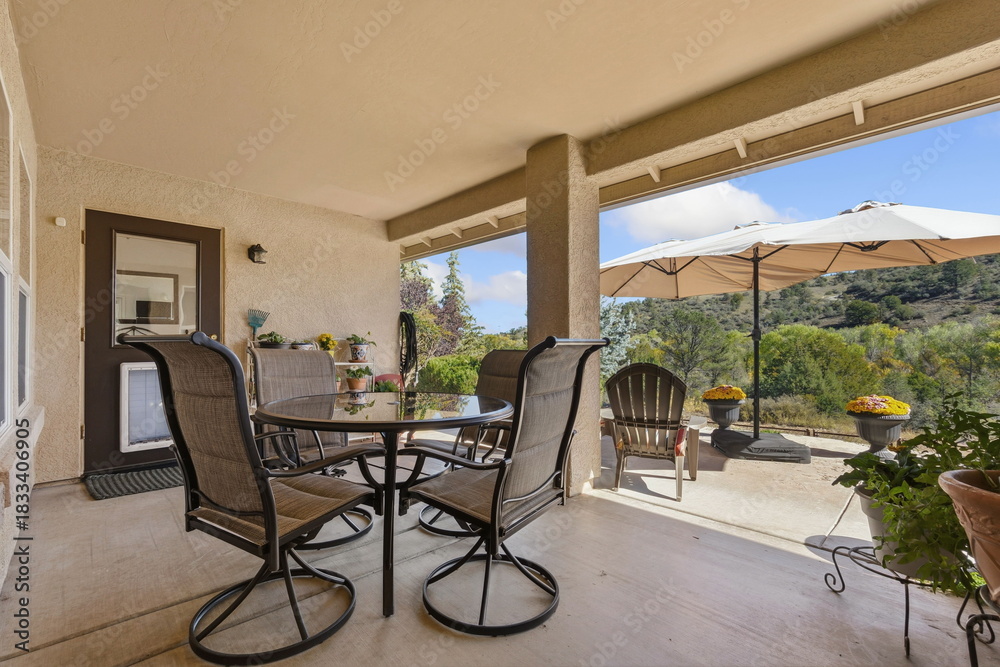 Naklejka premium Patio Umbrella For Scenic Outdoor Meals, Umbrella Over Patio Table Offering Views Of Hills And Valleys