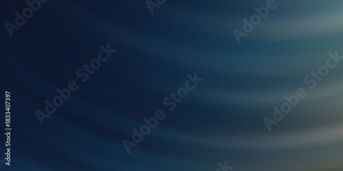 Dramatic dark blue sky with ethereal wispy clouds illuminated by soft diffused sunlight creating a moody atmospheric background