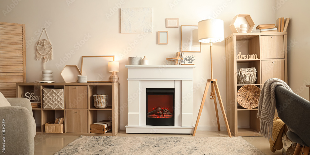 Fototapeta premium Interior of cozy living room with fireplace, shelving units and lamps