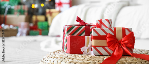 Christmas gifts on pouf in ...